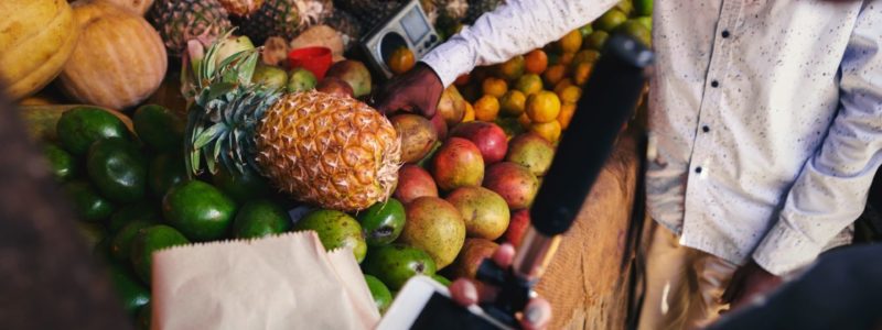 Young woman selects fruit on local African market