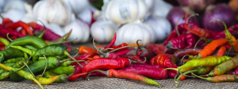 Zanzibar Cuisine exotic fruits and veg by locals Green pepper, chili and limes on the market in Stone town, Zanzibar