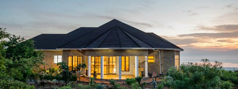 Uganda Lodges Elephant Plains. Exterior view with African sunset in the background.