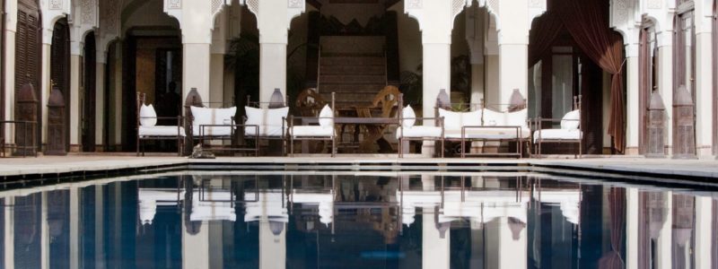 Pool and dining area view of luxury villa des Oranges. luxury exterior.