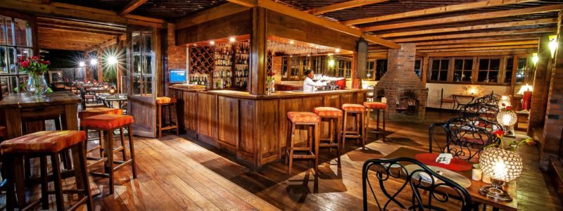 Warm and inviting bar and bistro at Arusha Coffee Lodge, the perfect start to a luxury safari in Tanzania.