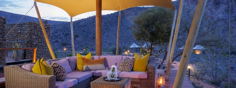 Sabona Barrydale outside seating area with furniture and lanterns. Overlooking South African mountains.