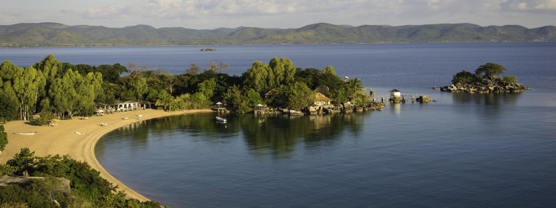 Kaya Mawa Aerial Luxury Malawi Lodges overview of beachfront golden sand and deep blue oceans.