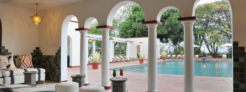 Victoria falls Villa. Decking, seating and pool area. With African vegetation and refreshments.