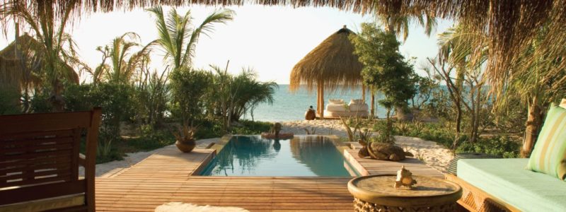 Tranquil luxury villa experience. Plunge pool African style decoration exterior. Overlooking beach and ocean.