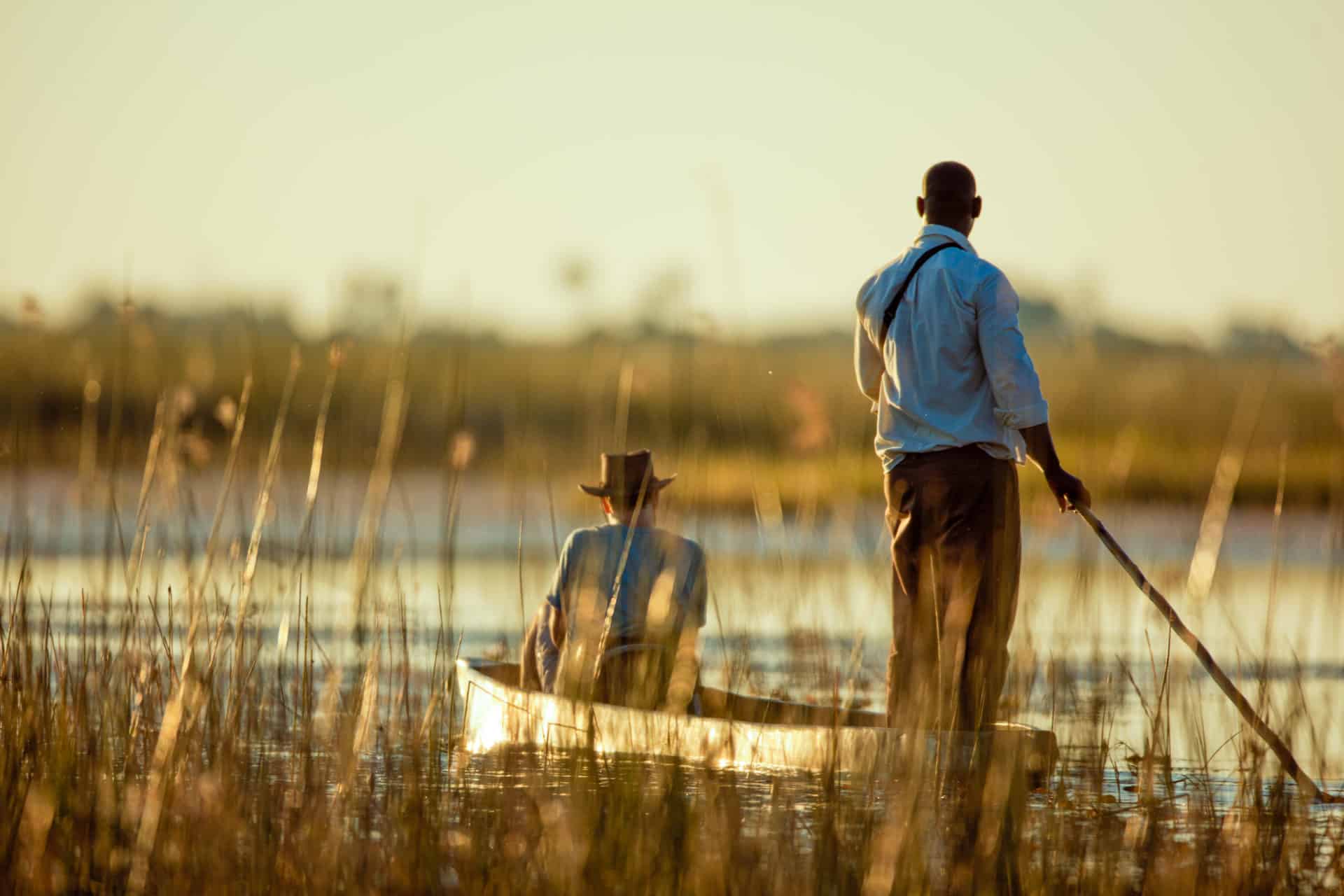 Boat ride at Mokoro Safari, Botswana. Male alone enjoying tranquil trip.