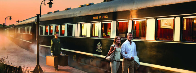 Couple Walking Near The Rovos Rail Luxury Train