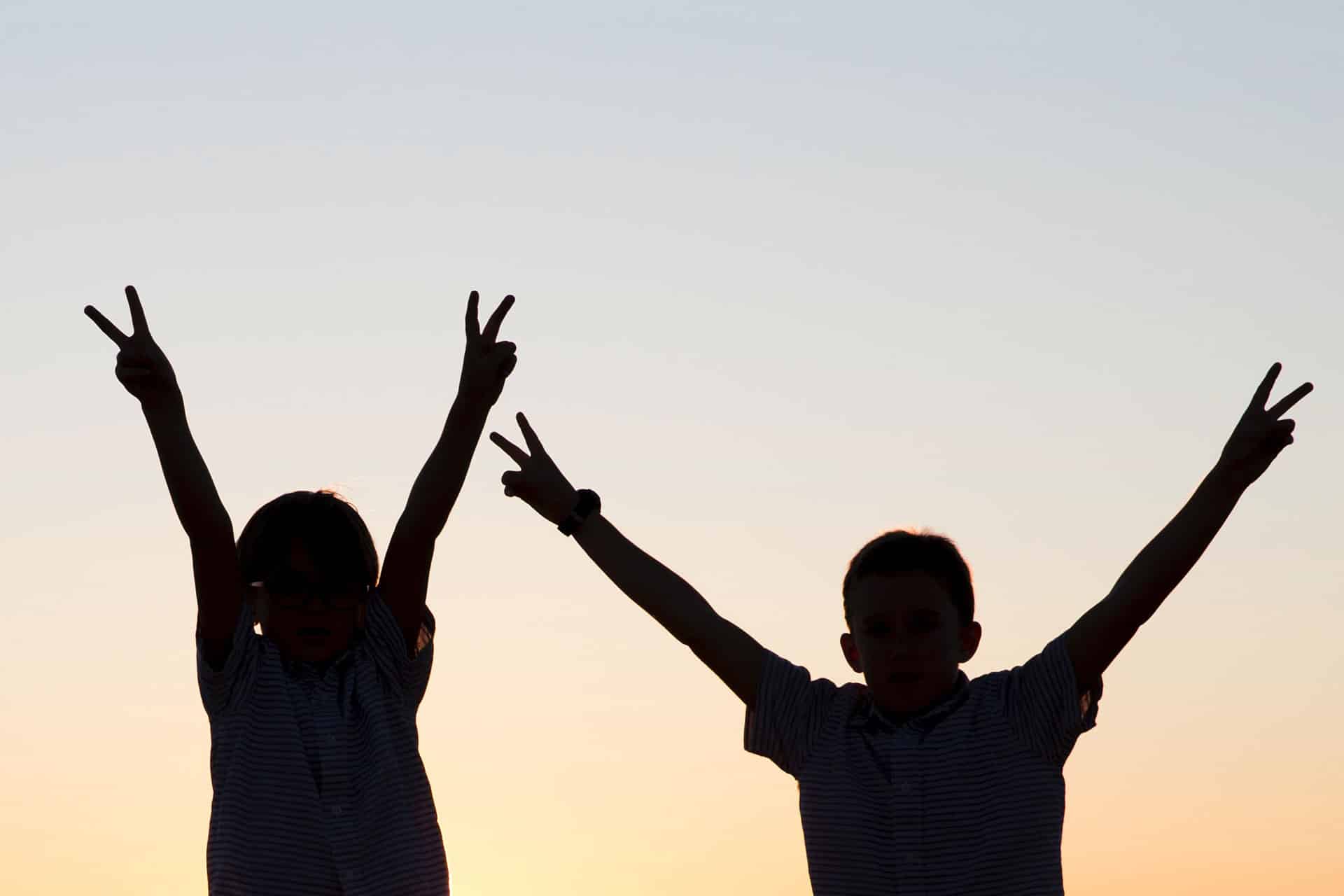 Children celebrating at sunset during a family safari in Africa
