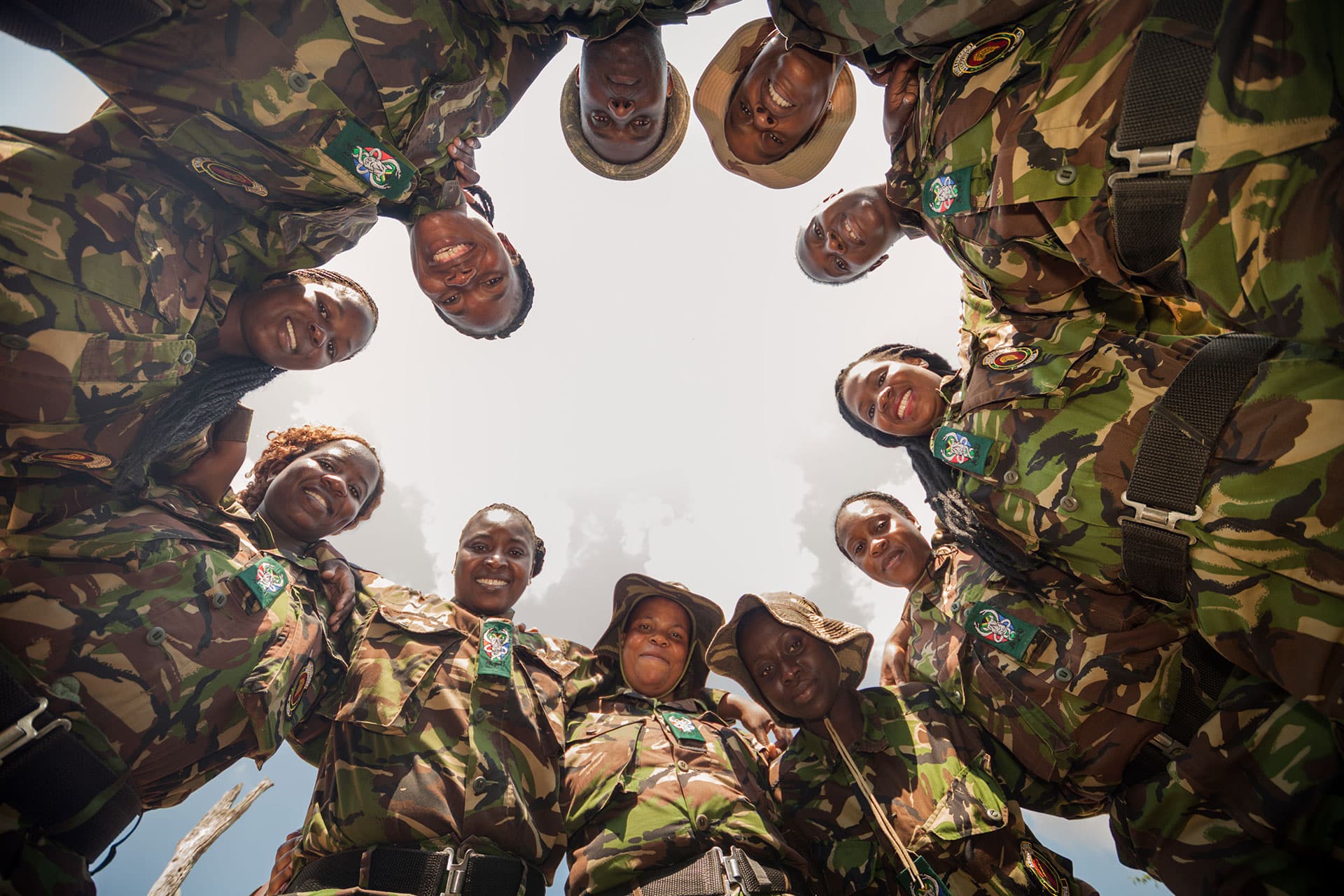 Women in a circle with their arms around each other looking at the camera. Conservation in South Africa