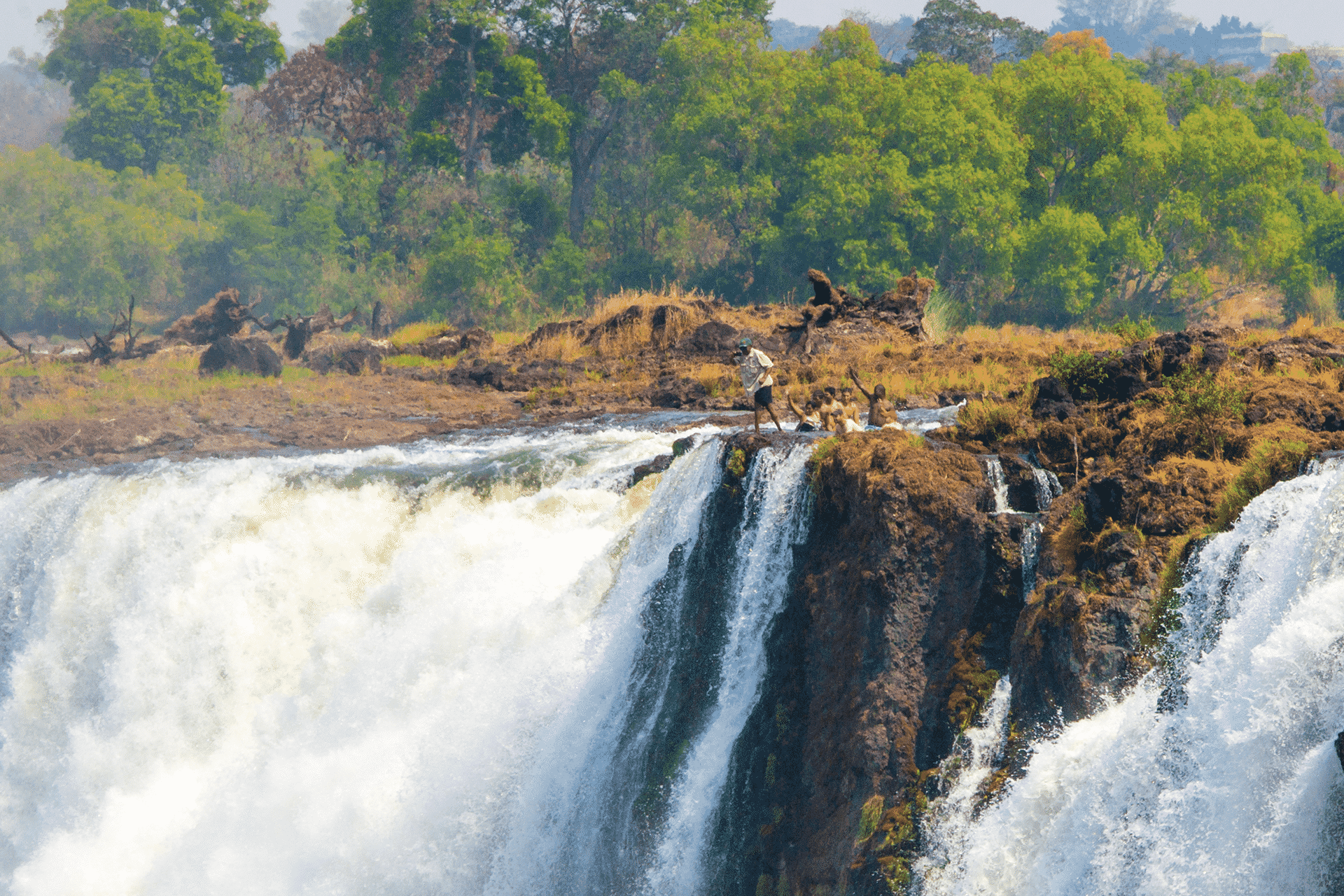 Guests swimming in Devil's Pool above Victoria Falls