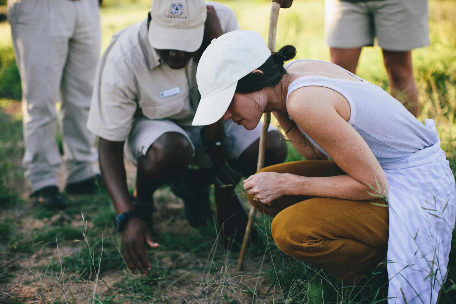A woman and a tracker on a safari in Africa. 