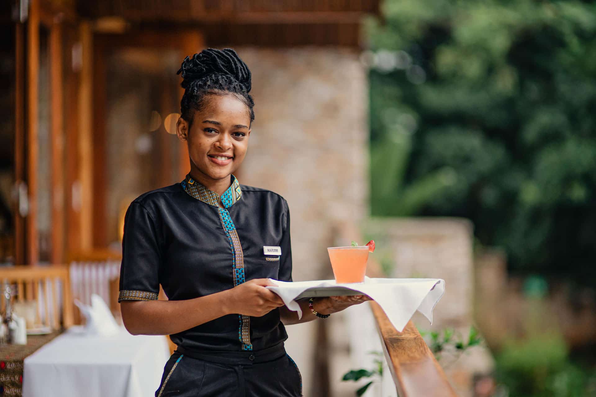 A waitress with a tray of drinks at The Retreat