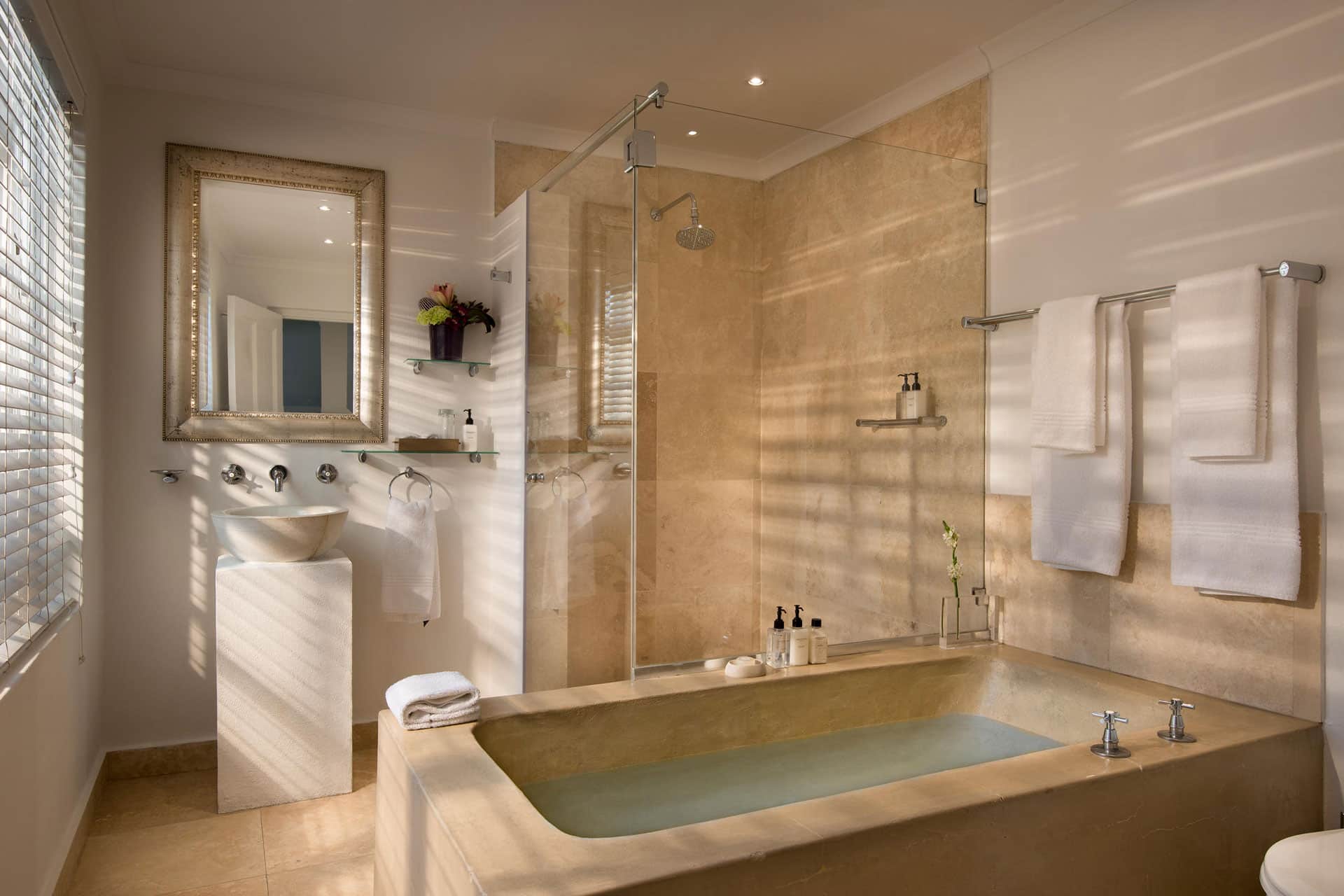 Concrete bath and large glass shower at the Cape Cadogan Boutique Hotel. 