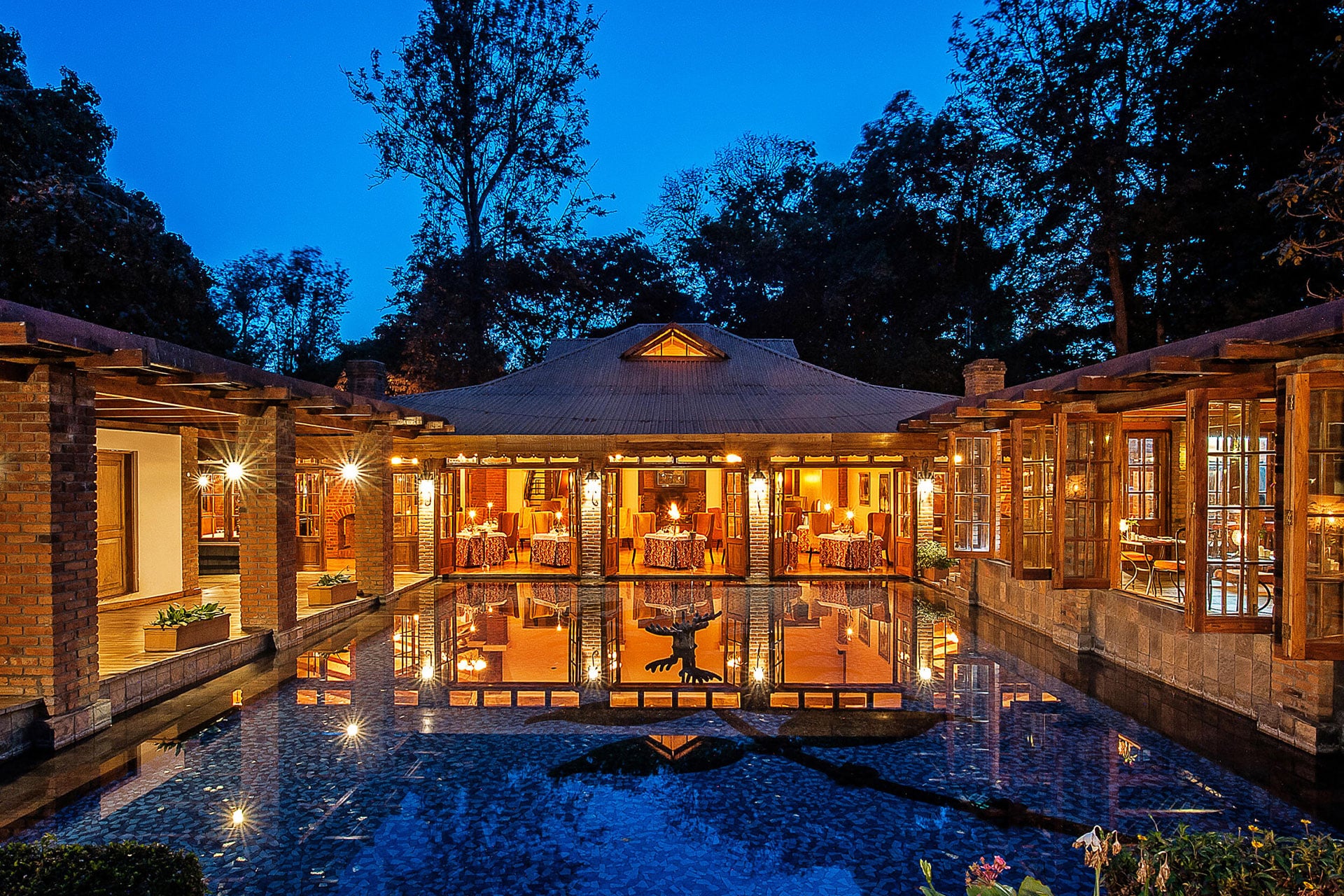 A hotel swimming pool at dusk at Arusha Coffee Lodge