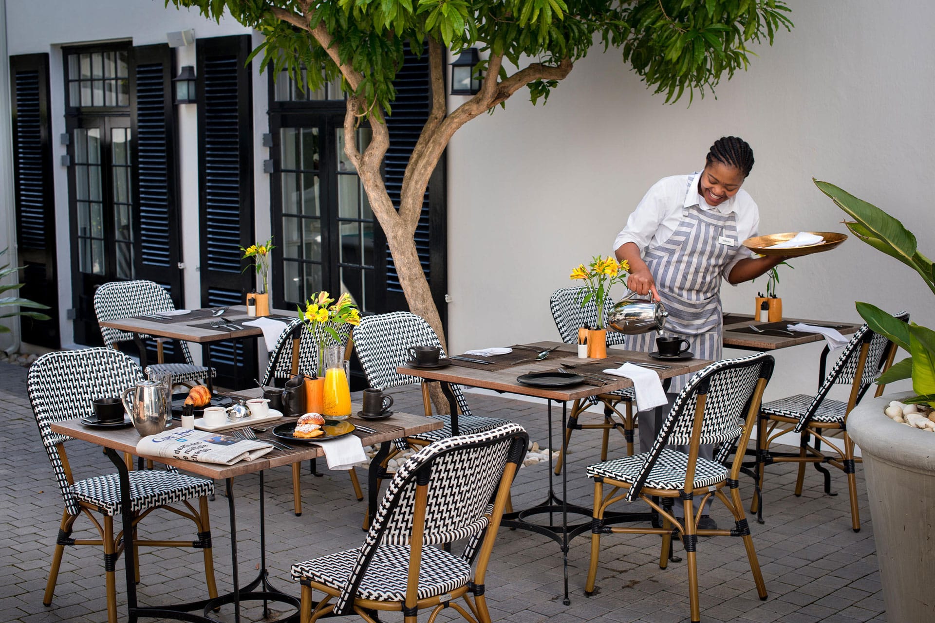 Cape Cadogan Boutique Hotel staff pouring coffee during breakfast
