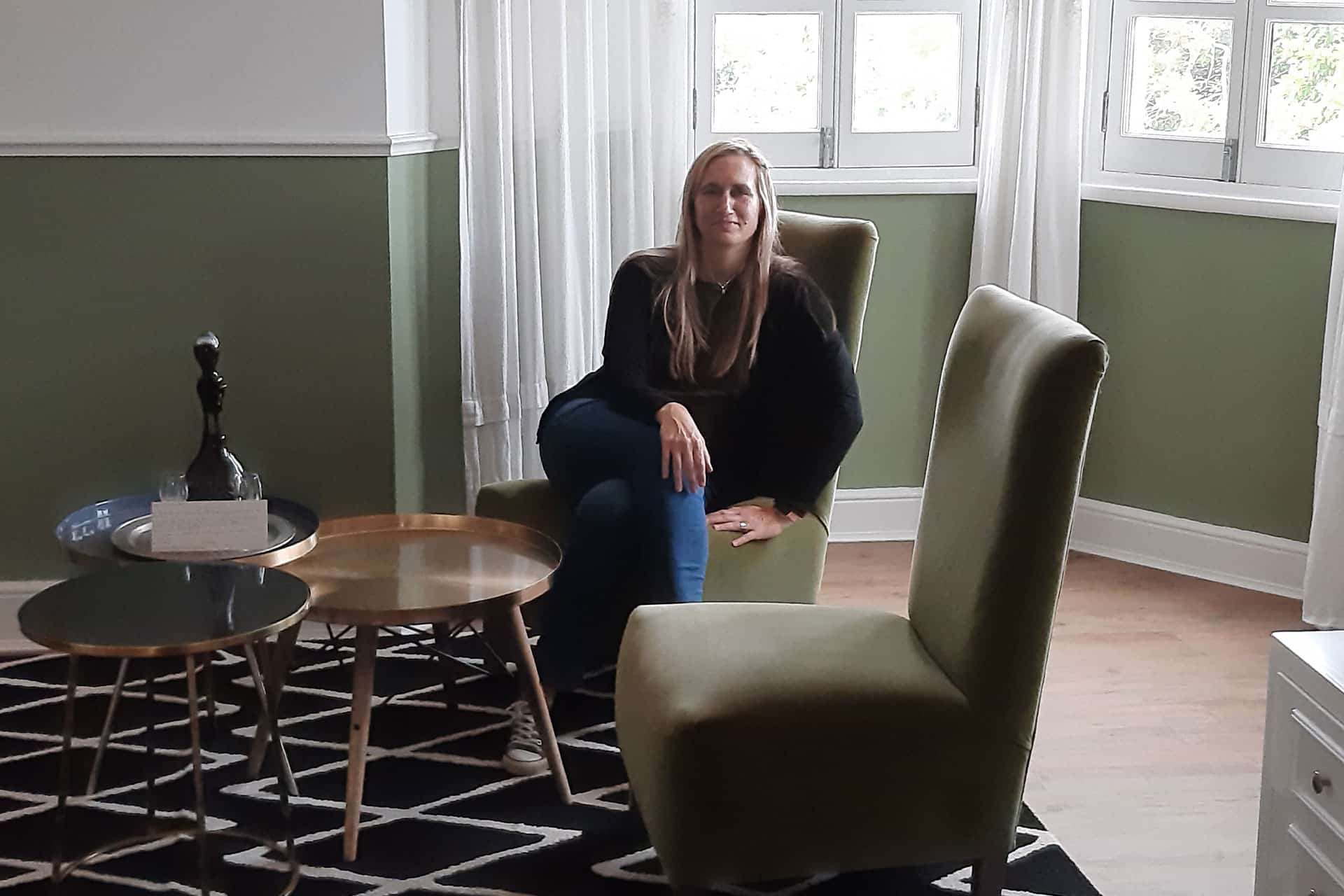 A woman sitting in a luxury room at the Cape Cadogan Boutique Hotel