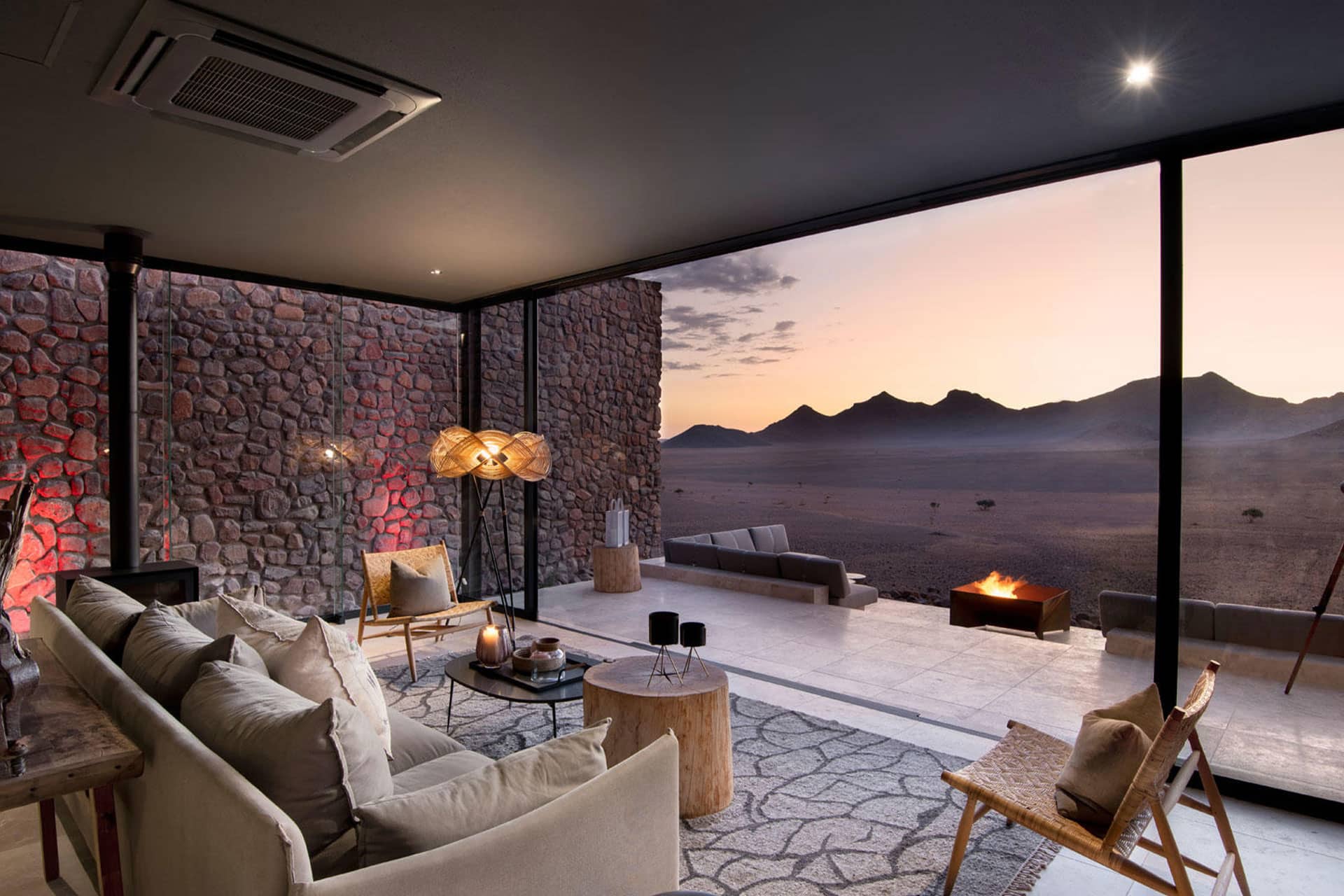 Stars in the sky on a night safari in the desert with Sossusvlei Desert Lodge in the background.