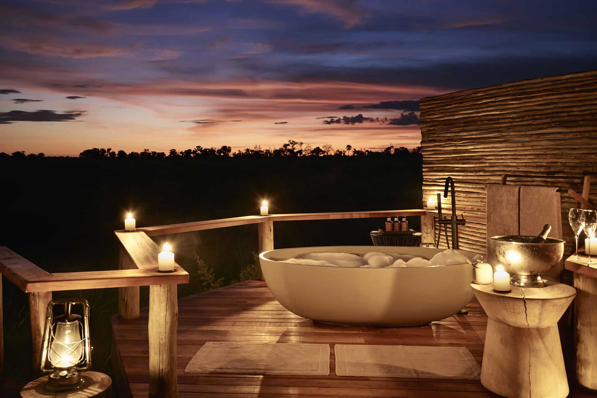 A sunset bubble bath with candles after a nights safari at Sanctuary Baines&rsquo; Camp.