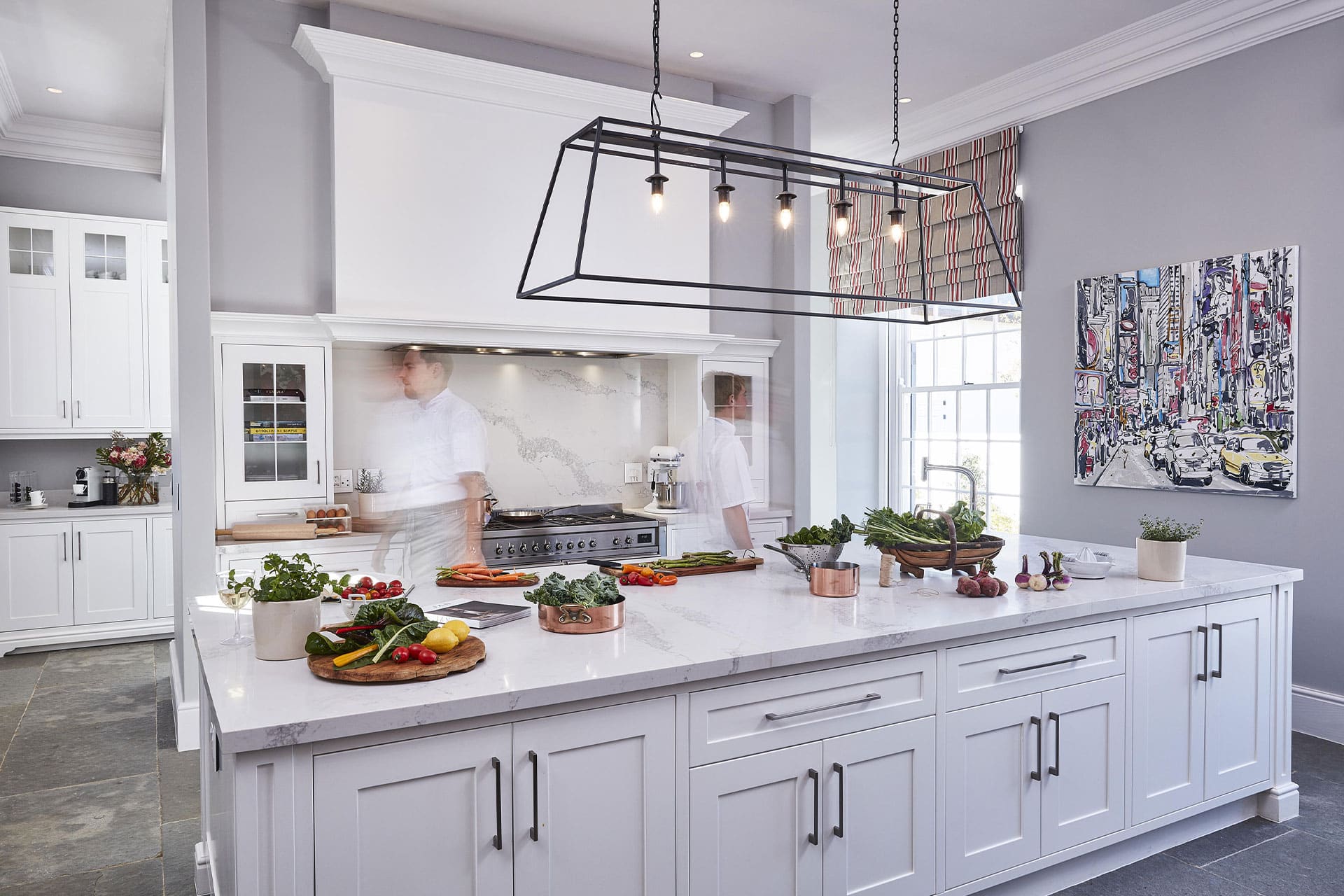 Food and wine laid out on a table on the patio overlooking the swimming pool at Brookdale Manor House. 