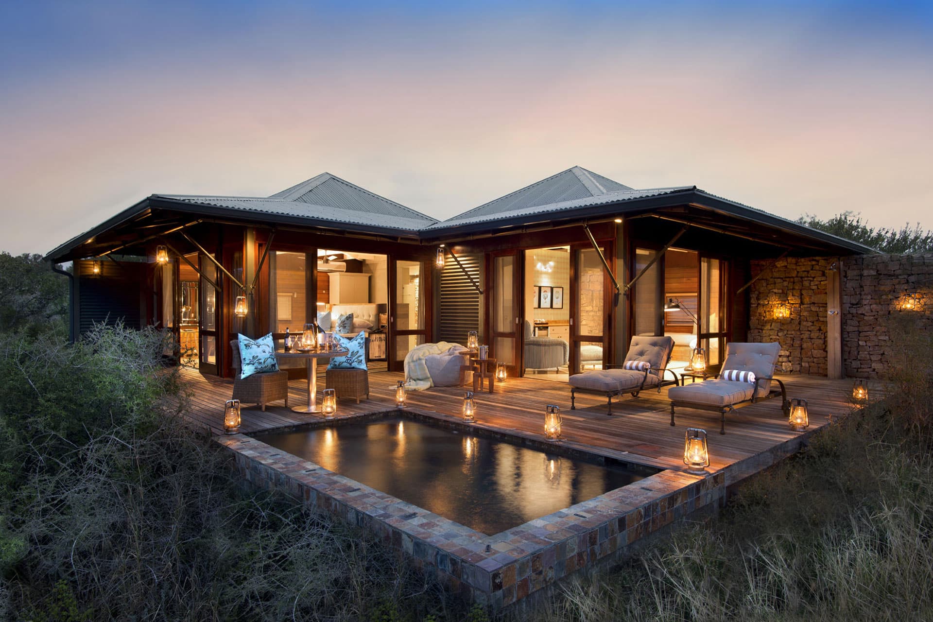 A double suite with private plunge pool at dusk at Ecca Lodge in Kwandwe Private Game Reserve.