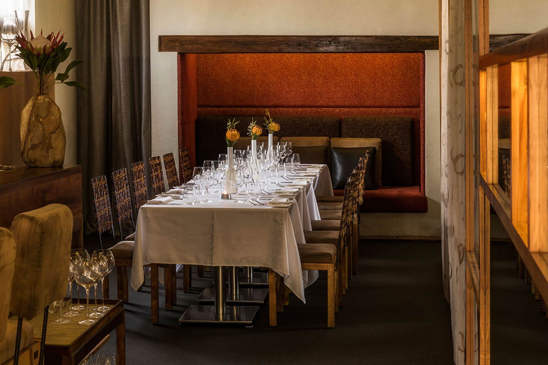 A dining table with chairs around it at Aubergine Restaurant &ndash; one of the top 10 fine dining restaurants in Cape Town.