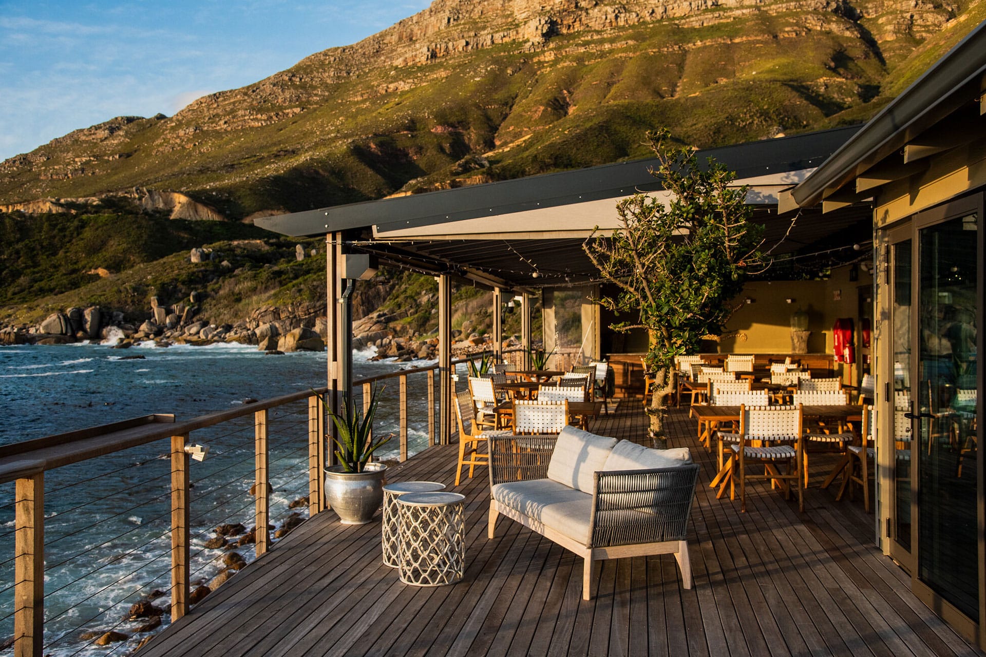 The al fresco dining area with views of the Table Mountain National Park and Atlantic Ocean at Chefs Warehouse Tintswalo Atlantic &ndash; one of the top 10 fine dining restaurants in Cape Town. 