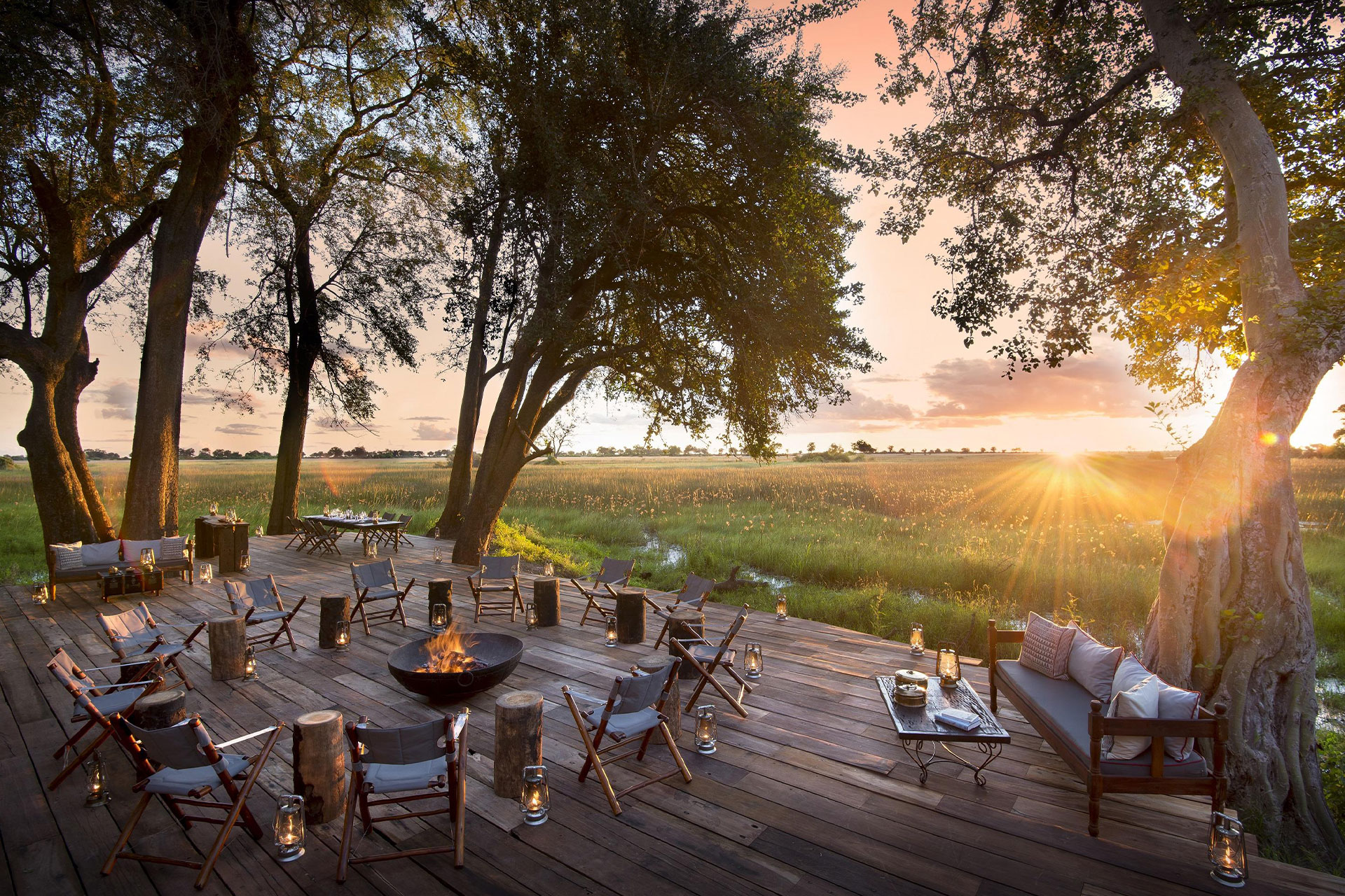Wooden deck and outdoor seating area at Duba Plains in the Okavango Delta, operated by Great Plains, founded by Dereck and Beverly Joubert. 