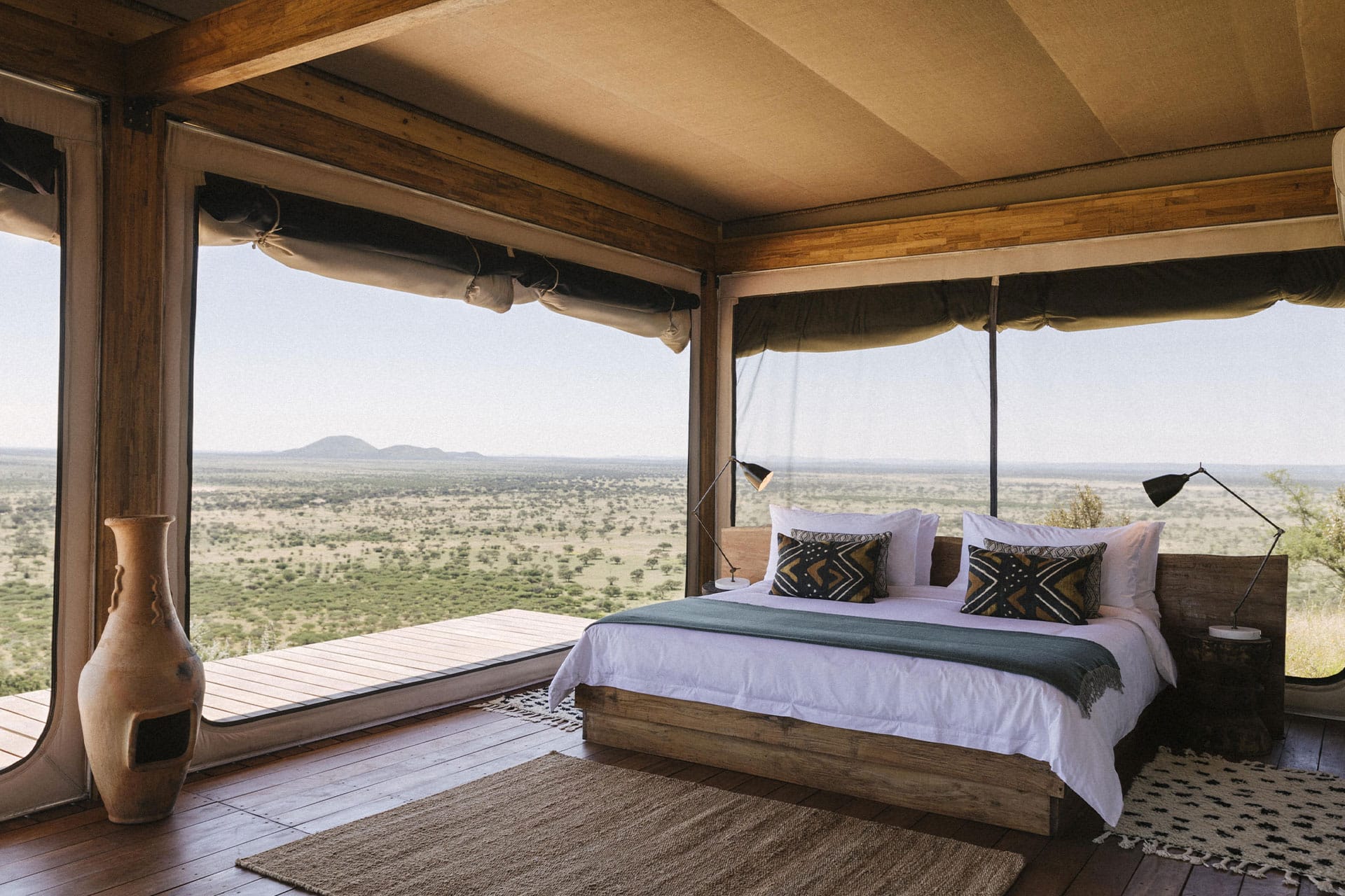 A bedroom in a tented suite at Habitas Namibia.