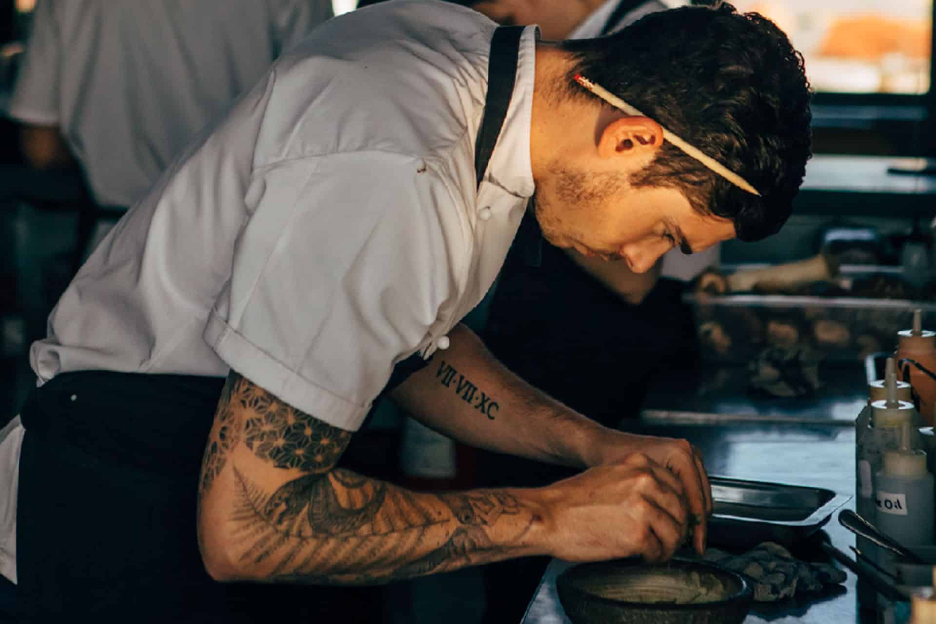 A chef plating food at The Pot Luck Club &ndash; one of the top 10 fine dining restaurants in Cape Town.