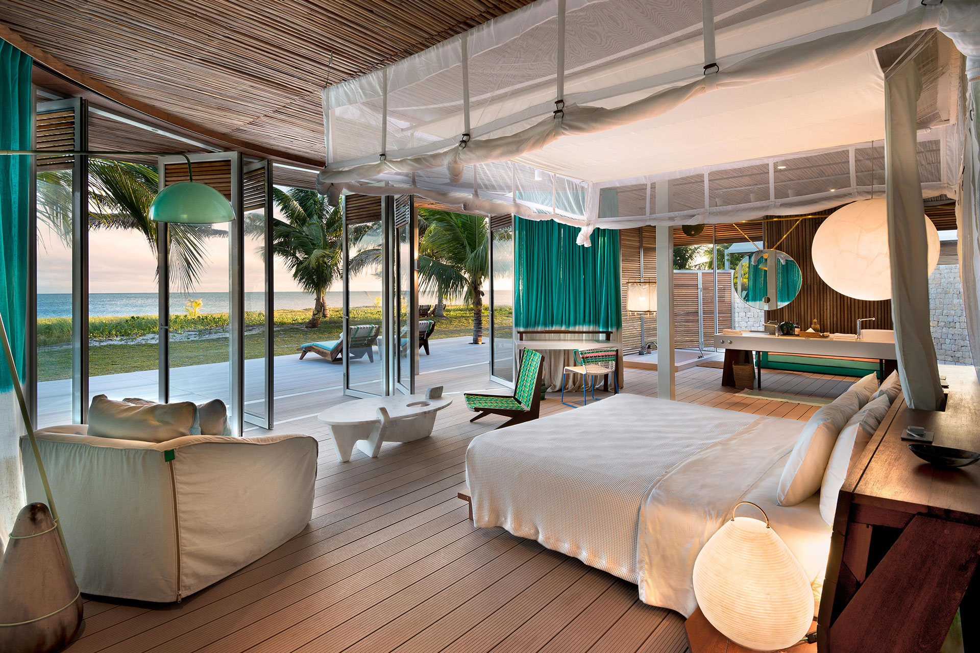 The interior of a private beachfront villa at Time + Tide Miavana, Madagascar, with views of the Indian Ocean. 