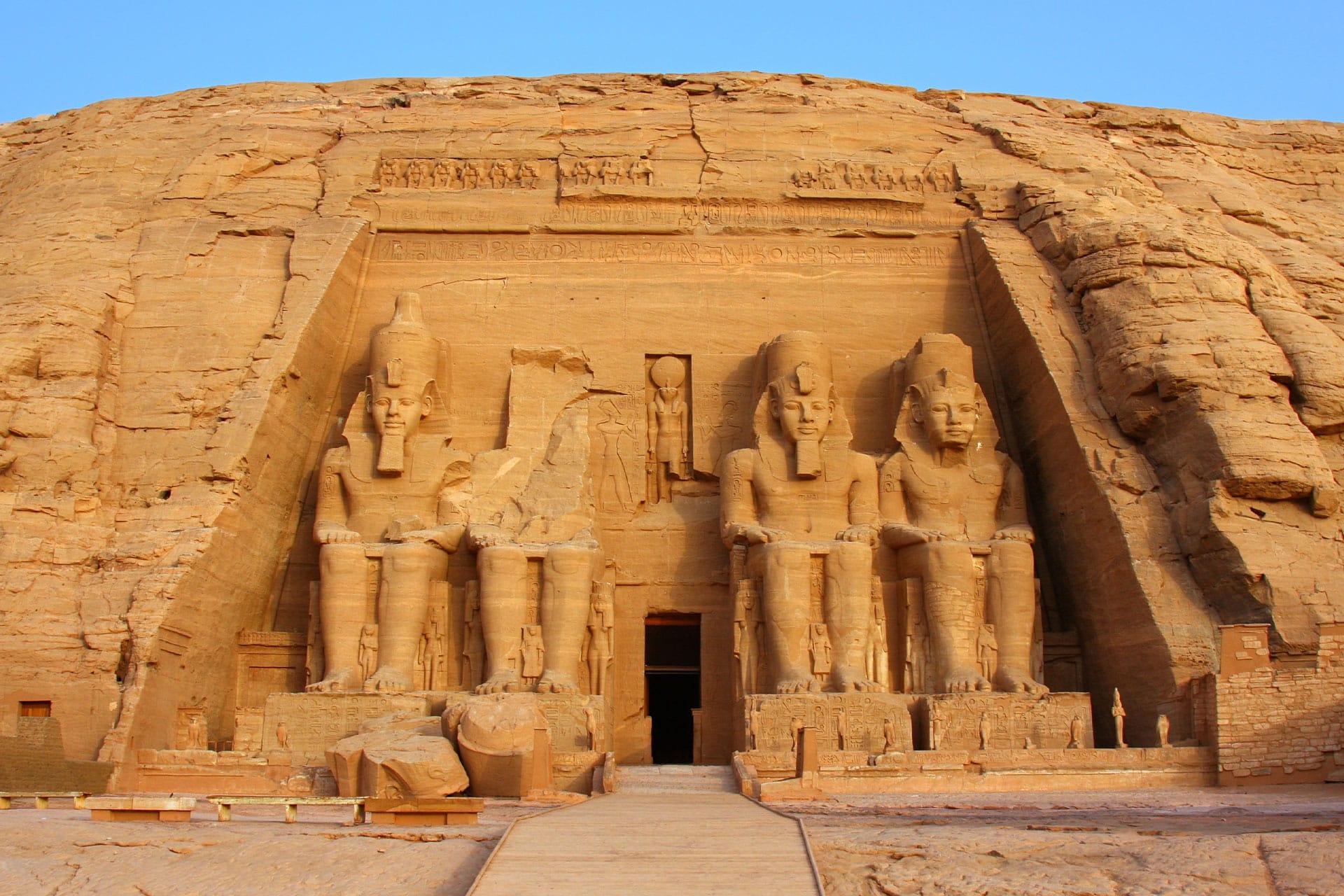 The grand Abu Simbel temple complex in Egypt, featuring towering statues of Ramses II, showcasing the country's ancient history and architectural marvels.