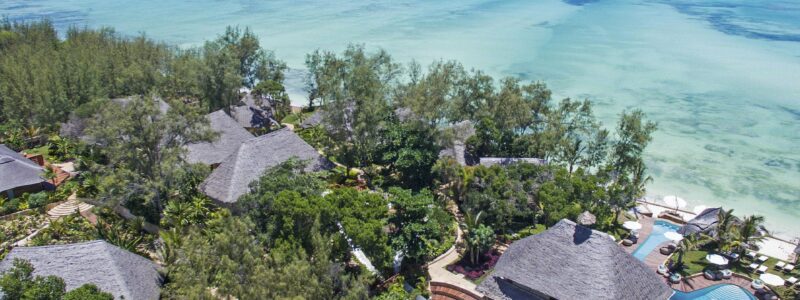 Zuri Zanzibar aerial overview of villas green trees and ocean seafront views.