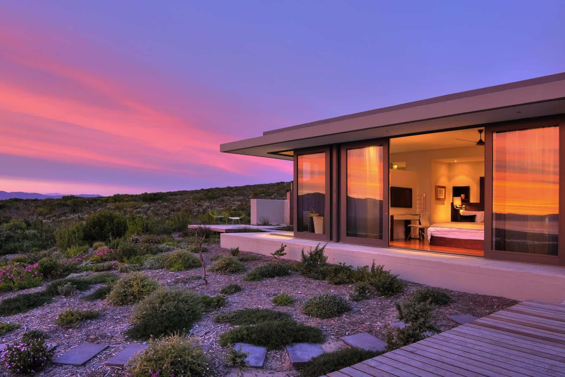 A private villa on the fynbos reserve during sunset at Grootbos Private Nature Reserve &ndash; one of the top Eco Lodges in Africa.