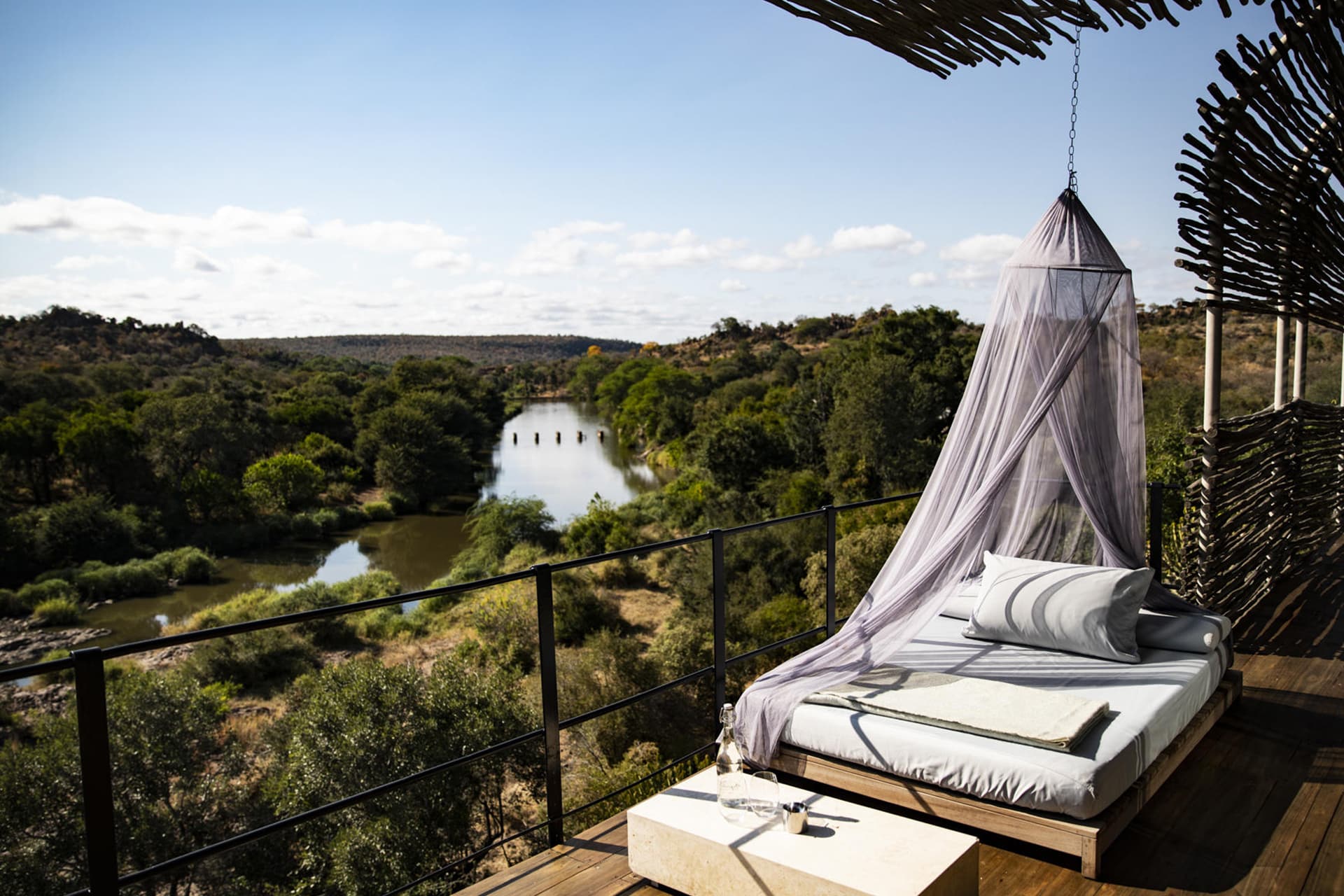 A bed on a viewing deck at Singita Lebombo &ndash; a recommended destination for honeymoons in Africa. 
