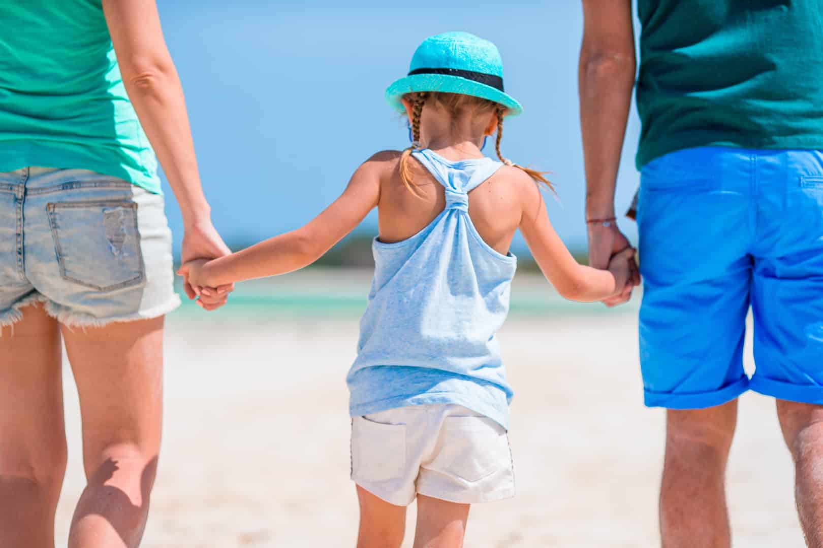 A family stroll down Kendwa beach near Gold Zanzibar &ndash; one of the top rated Zanzibar resorts with Kids Clubs. 
