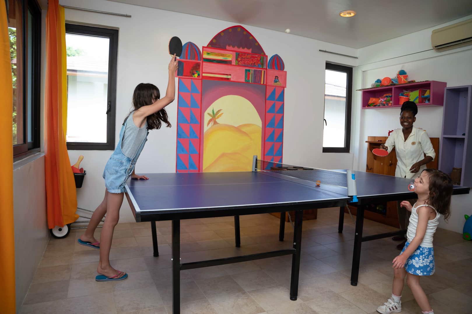 Kids enjoying a game of ping-pong at the Residence Zanzibar&rsquo;s Kids Club &ndash; one of the top rated Zanzibar resorts with Kids Clubs. 