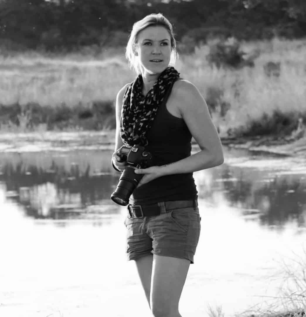 Natasha Langley with binoculars at a waterhole