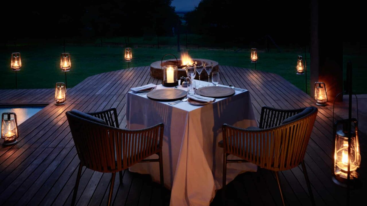 Romantic dinner with candles, in the Chobe Chilwero Botswana Okavango Lodge.