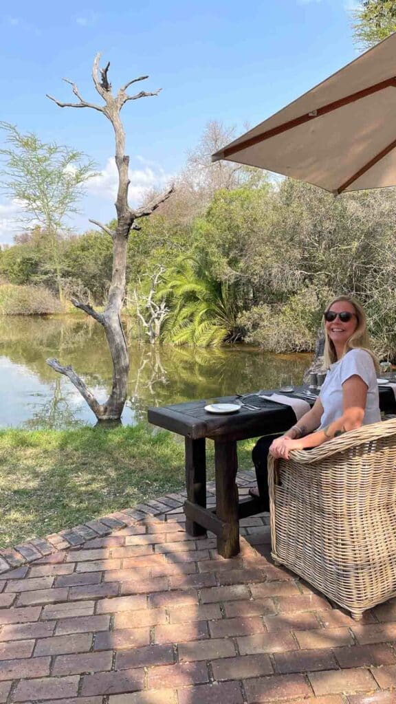 Table set in front of a waterhole for lunch at Jabulani Safari.