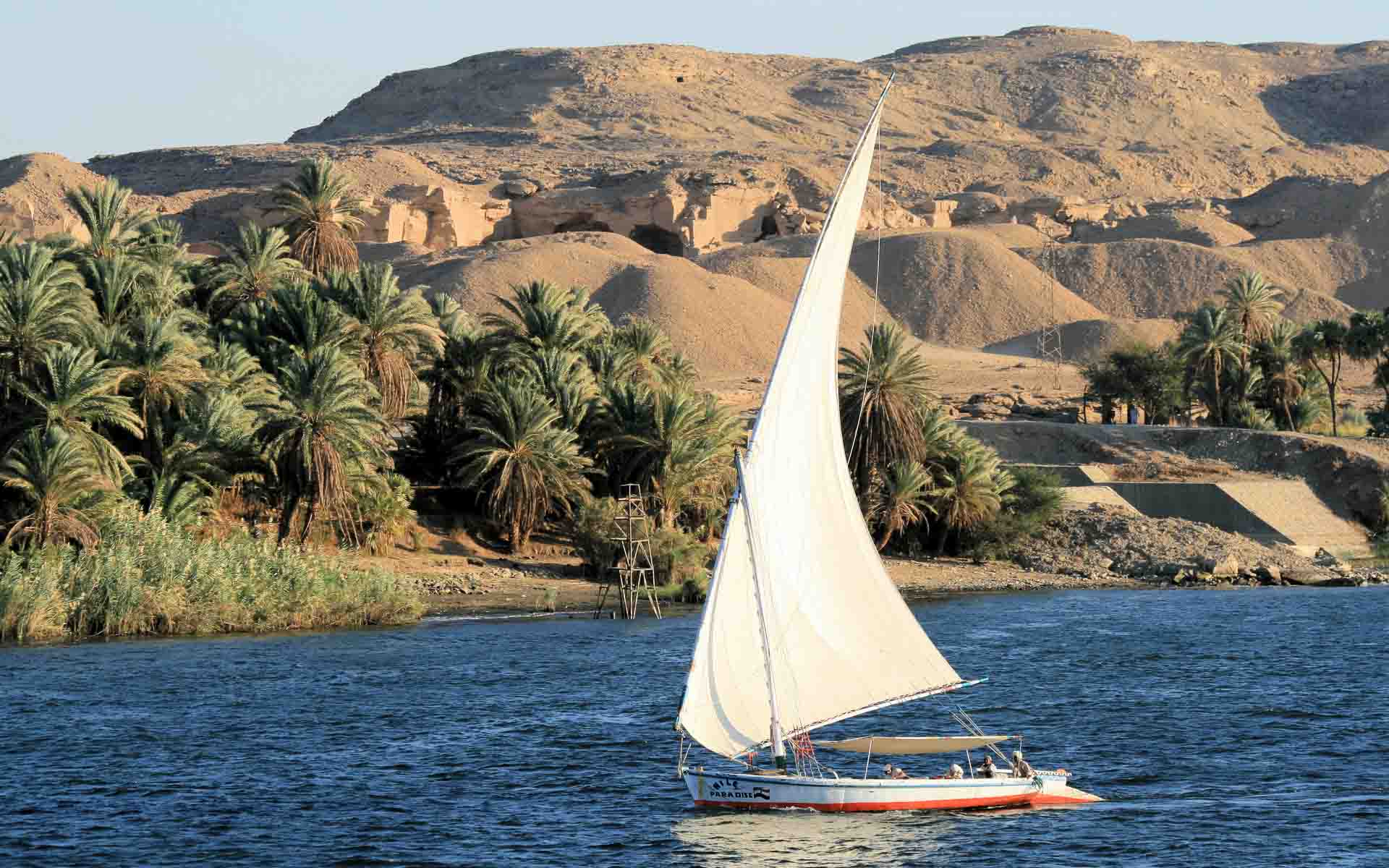 A felucca boat cruising down the Nile River - one of the Seven Natural Wonders of Africa.