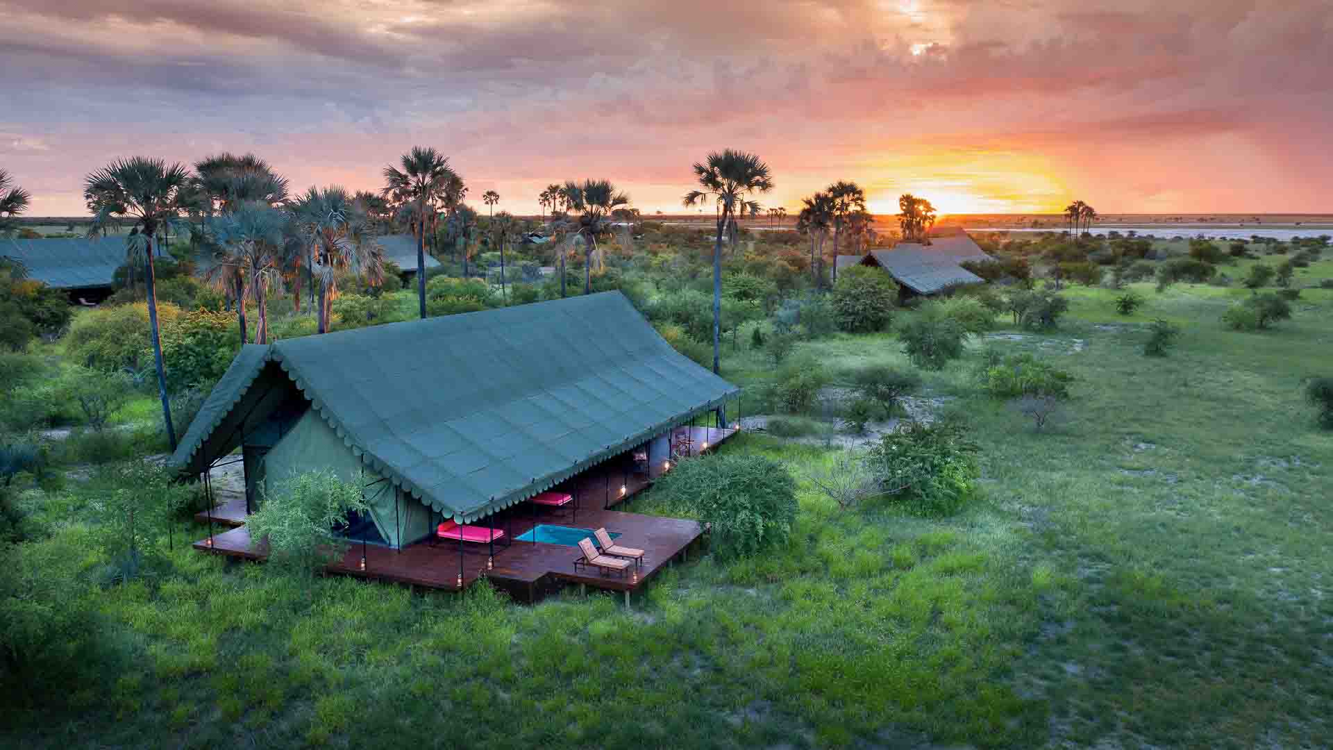 Jack&rsquo;s Camp pictured against a moody Kalahari sky - an excellent place to stay during a Southern Africa safari off the beaten track.