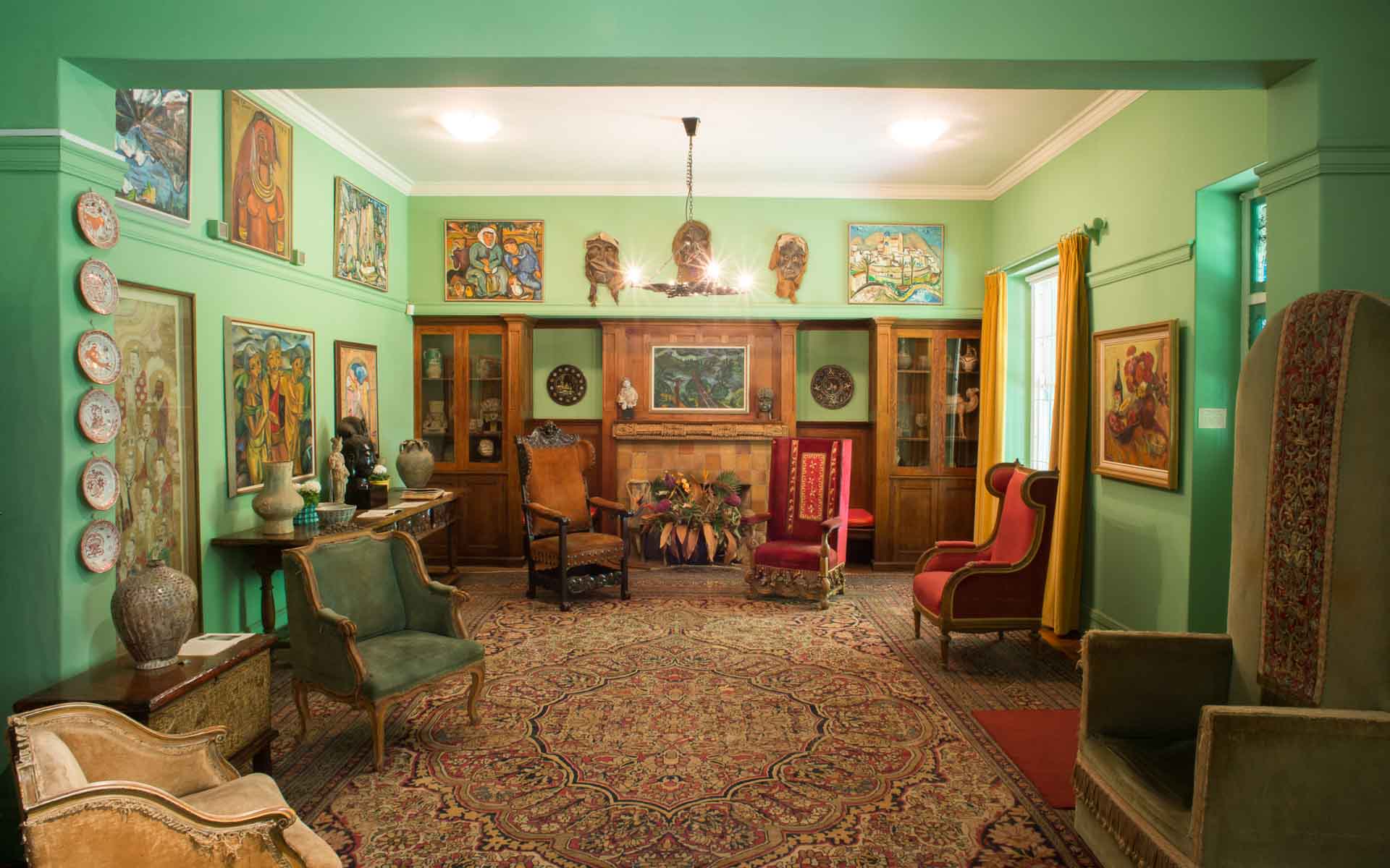 Artworks and eccentric furnishings in the lounge of the late artist, Irma Stern &ndash; a glimpse into one of the top art galleries in Cape Town. 