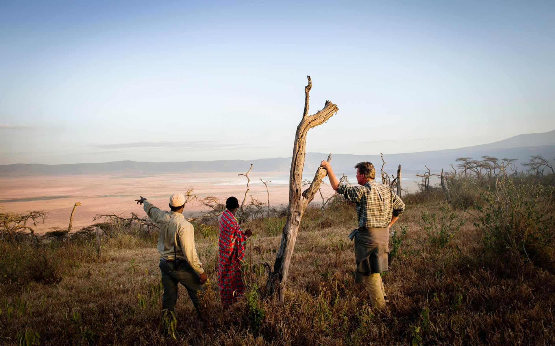A guide and guests looking into the Ngorongoro Crater, part of Ker & Downey Africa&rsquo;s best Africa safaris of 2022. 