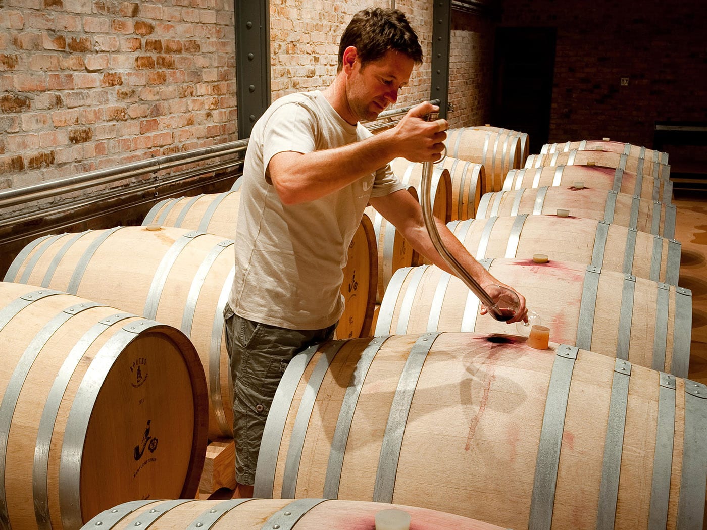 Man and wine barrels with Ker & Downey® Africa