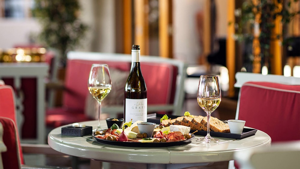 Food and wine on a table at Delaire Graff with Ker & Downey® Africa