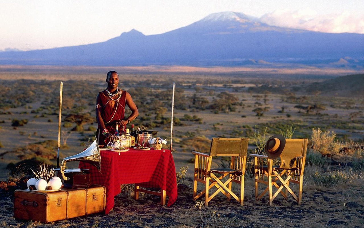 A Maasai man welcoming guests for sundowners at Elewana Tortilis with Ker & Downey&reg; Africa