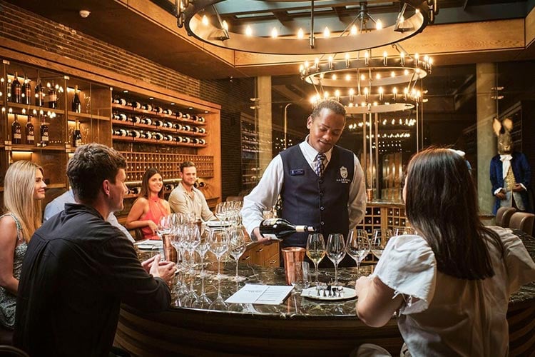 Man pouring wine for guests at Hazendal in Stellenbosch with Ker & Downey® Africa