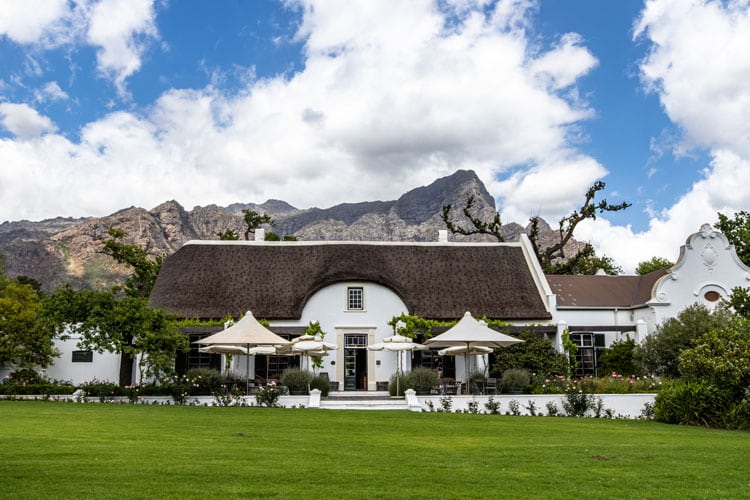Manor House with lawns in front of mountain with Ker & Downey® Africa