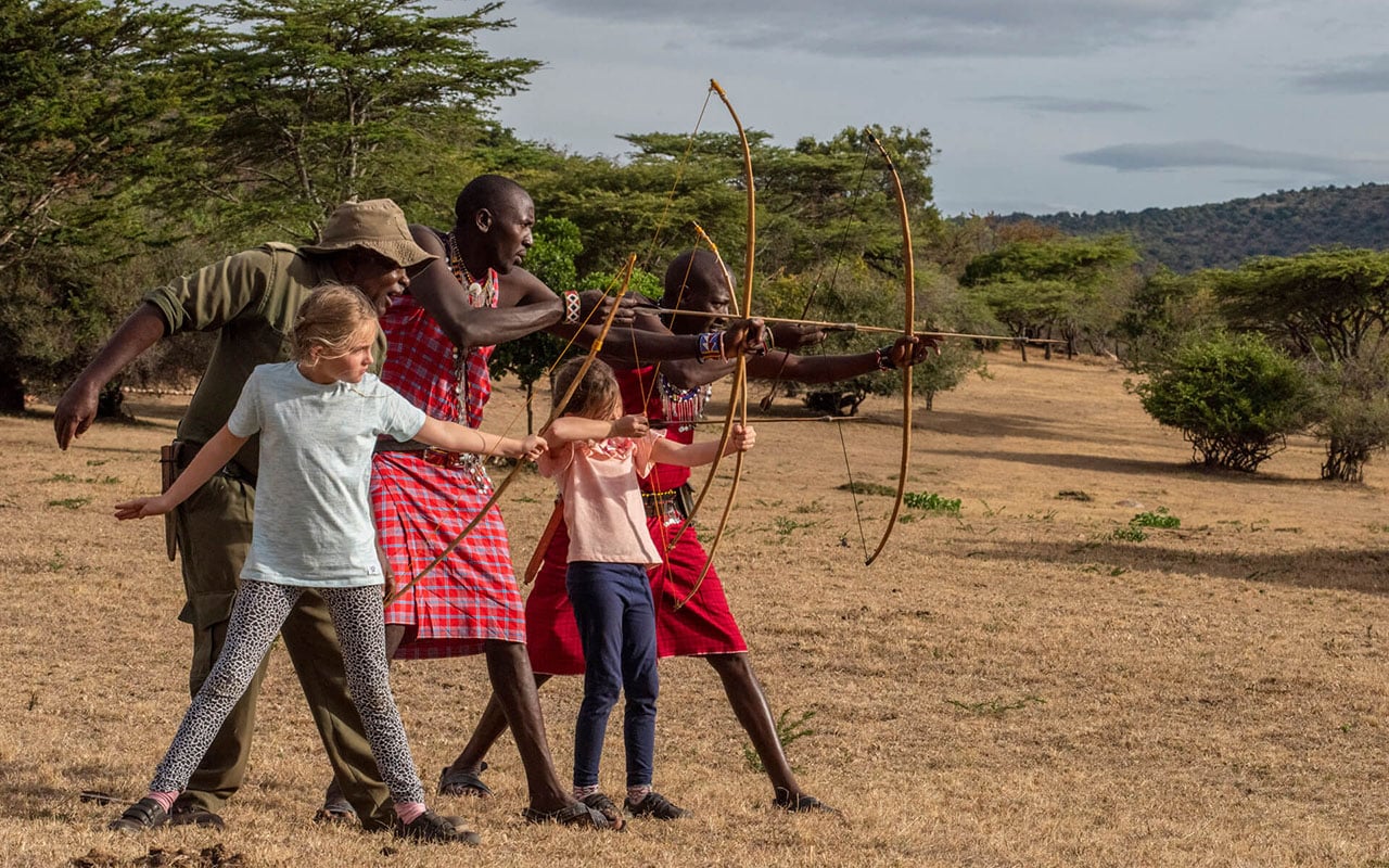 Kids and Maasai with bow and arrows at Cottar&rsquo;s Safari with Ker & Downey&reg; Africa