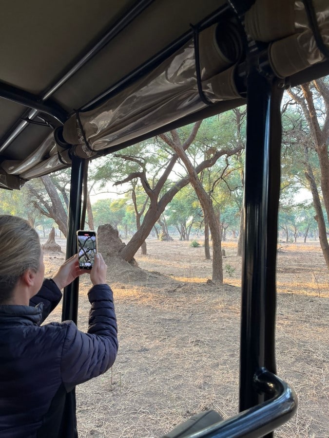 Sarah Morris on a game drive with a cell phone camera at Lolebezi with Ker & Downey Africa
